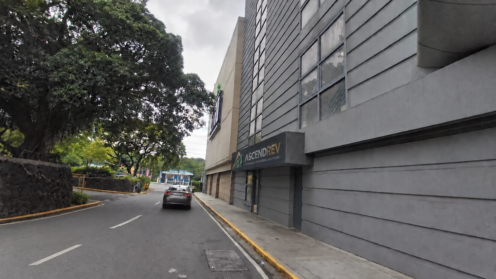 Exterior of the AscendRev campus with its icon on the building sign.