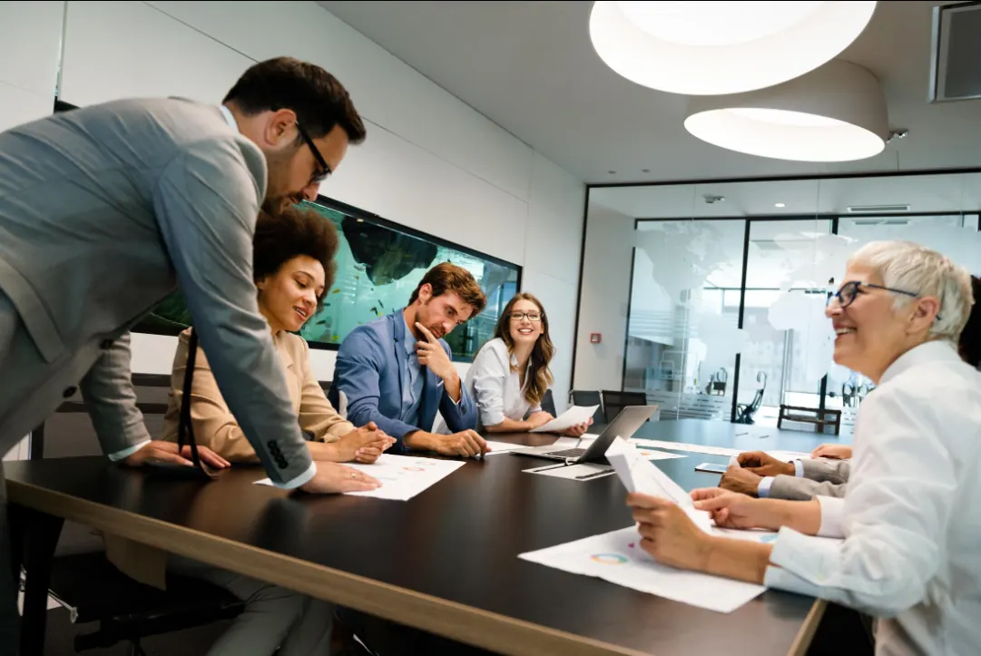 AscendRev colleagues collaborating around a conference table in a modern office.