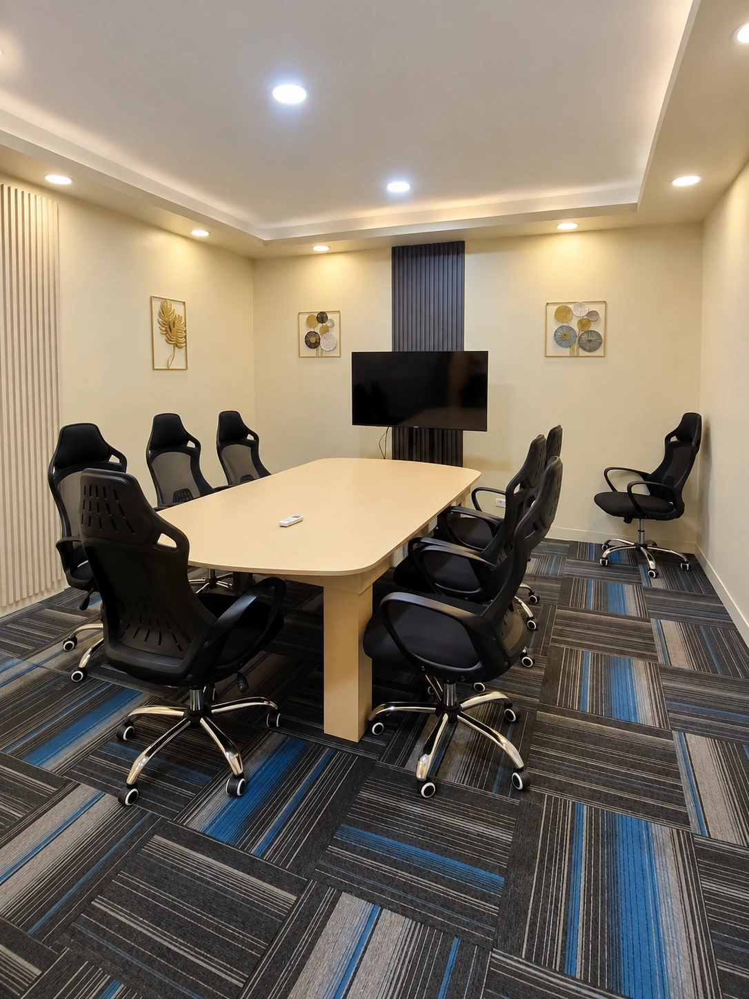 Client supplied view of a furnished meeting room with a conference table and chairs.
